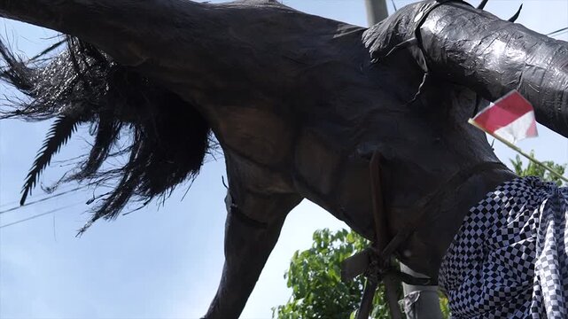 Low angle shot of a large black Ogoh-Ogoh effigy for Balinese Nyepi ritual in 4K resolution.