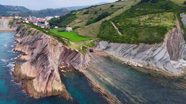 Drone view of Zumaia village and Flysch cliffs along the coast of Basque Country in Northern Spain, trail along the Atlantic coast of Spain, aerial view of Zumaia, famous tourist destination in Basque