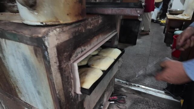 Traditional Xizhou Baba Baking Process in Dali, Yunnan, China, Handmade Flaky Flatbread Entering a Hot Oven