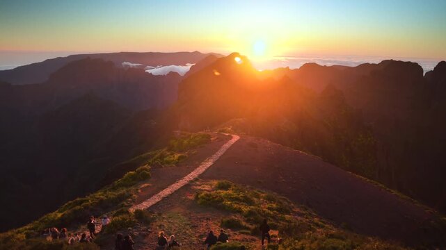 Stunning timelapse of a vibrant golden sunset above the clouds at Pico do Arieiro mountain peak in Madeira, Portugal. 