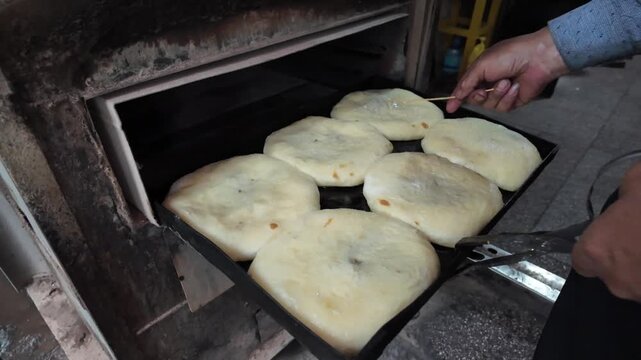 Traditional Xizhou Baba Baking Process in Dali, Yunnan, China, Handmade Flaky Flatbread Entering a Hot Oven