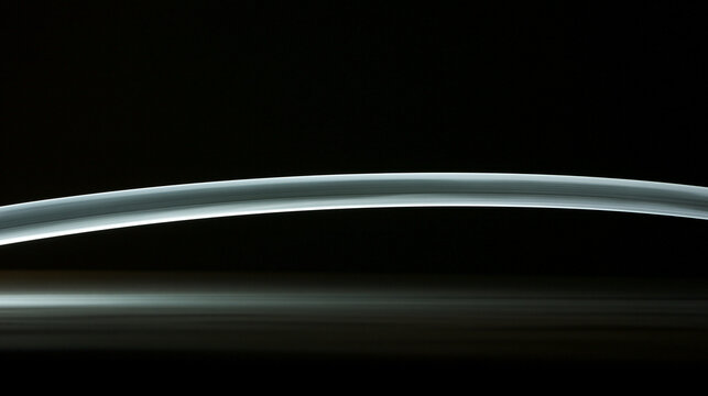A white arc of light tracing the path of a moving sword.