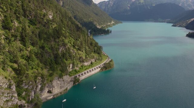 Aerial View of Scenic Road Along Turquoise Achensee Lake in Tyrol, Austria