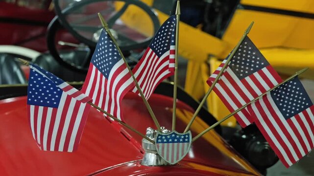 American flags on the front of a classic car	
