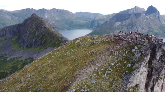 Drone shot of iconic razor sharp mountain peak and ocean fjord in Northern Norway