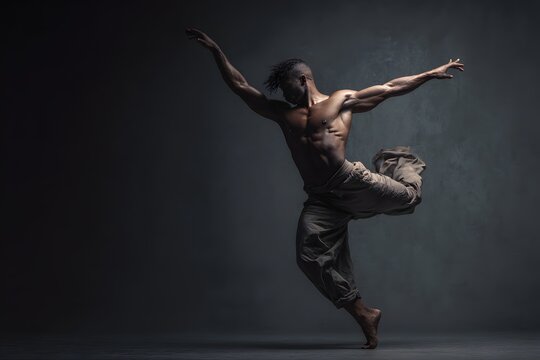 Male Dancer Performing Dynamic Leap on Dark Stage with Dramatic Lighting