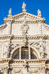Fototapeta premium Ornate statues decorate the grand baroque facade of San Moise church in Venice, Italy
