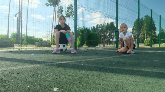 Young athletes hold different balls at community fitness park before play. Variety develops coordination, variety encourages curiosity, and variety introduces children to multiple active routines.