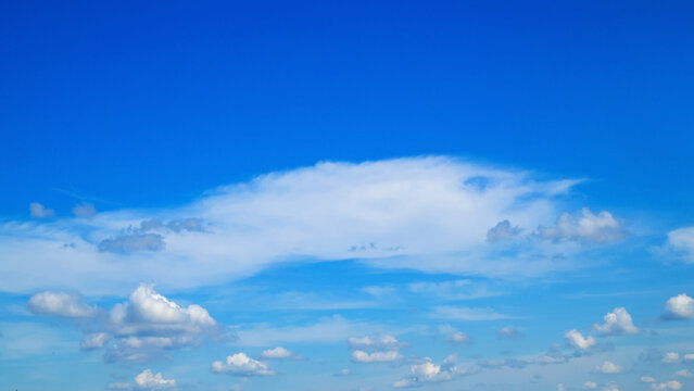 cirrus and light clouds stretch across a blue sky on a sunny clear day