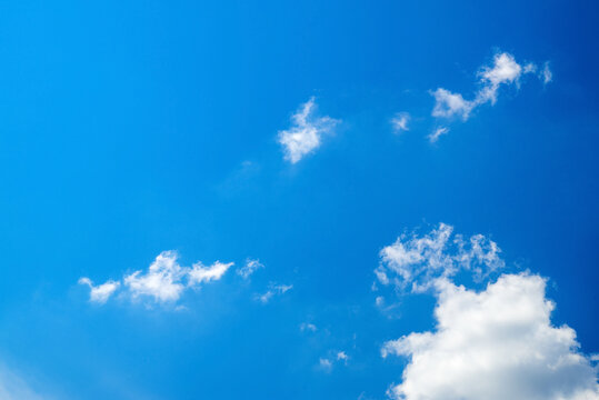 small translucent clouds in the lower right corner of a bright blue clear sky