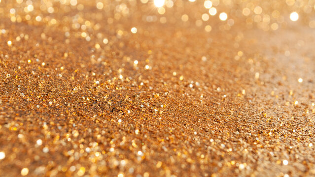 Gold glitter shining under soft light in a close-up view during the daytime