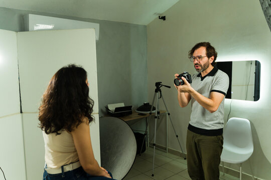 Male photographer evaluating a female model during a studio casting session for a talent audition