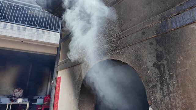 Burning Joss Paper Ritual at a Taiwanese Temple, Sacred Smoke Rising Toward the Sky During Traditional Worship Ceremony