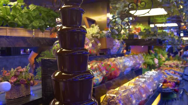 Chocolate fountain with colorful candy buffet display