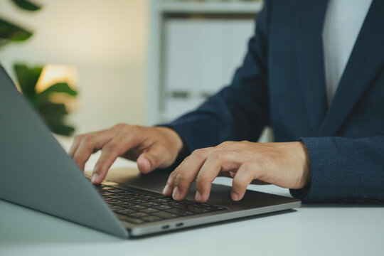 Business laptop typing closeup businessman working on keyboard for online productivity digital workflow remote office communication data entry and professional technology tasks.