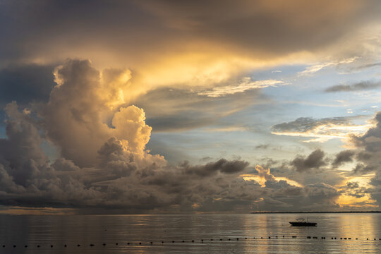 Dramatic sunset over the ocean with orange colour cumuls clouds