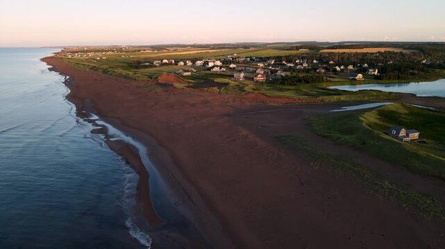 High-angle aerial panorama of long red sand beach on Prince Edward Island, Canada