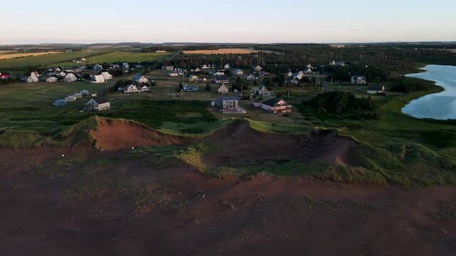 Aerial view of coastal dunes and cottage village on Prince Edward Island, Canada