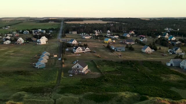 Aerial view of rural coastal houses and green fields on Prince Edward Island