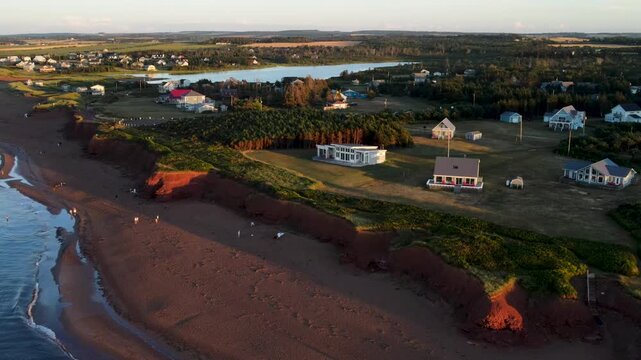 Prince Edward Island, Canada, Coastal homes between red sand beach and inland pond, aerial view
