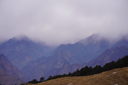Cloud covered Himalayan mountain range with rugged peaks