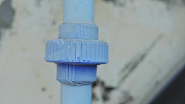 Close Up of Blue PVC Pipe Union Connector Plumbing Joint
