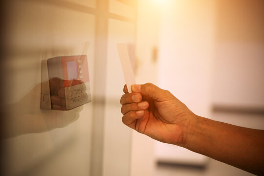 Hand scanning proximity ID card on reader access control system to security door unlock with identity or verification identify icons for safety detect fingerprint scan or check attendance.