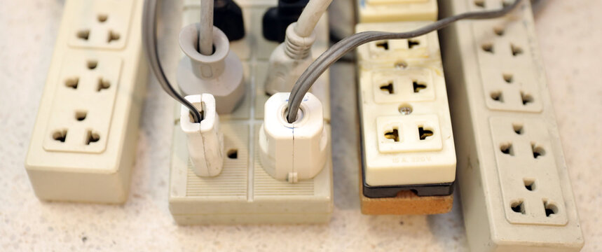 Old electrical extension cords plug is broken case damage and danger or connector voltage power burnt overload