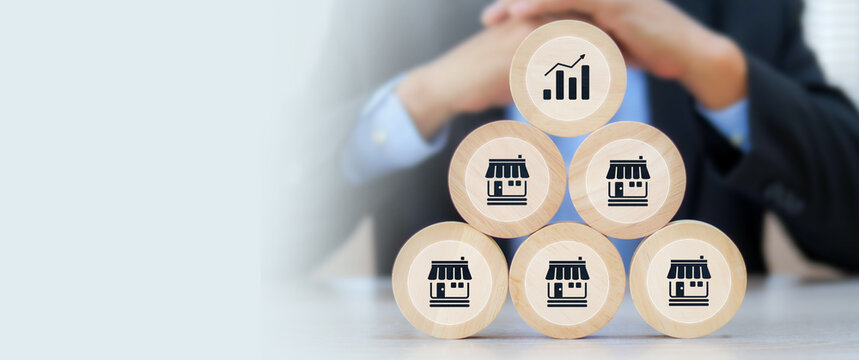 Wooden toy stack with franchise icon for goal to growth is investment planning financial and branch expansion and management bank loans for marketing franchising.