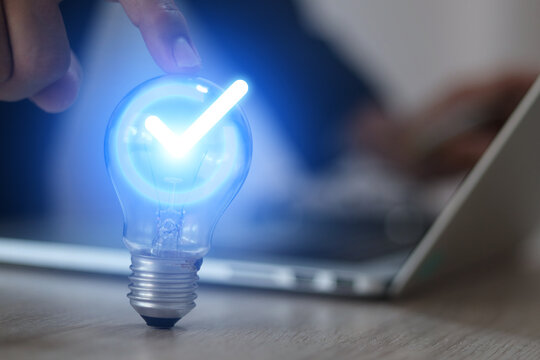 Businessman's hand is choosing light bulb for business creativity plan to goal or creative idea innovation or analyzing marketing data management and target growth or human resources.
