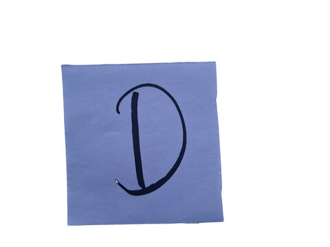 Single uppercase letter "d" in bold black marker handwriting on a light blue paper square, isolated against a black