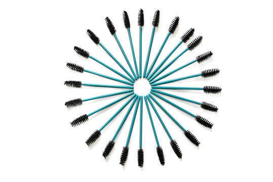 Blue disposable eyebrow and eyelash brushes arranged in a circular pattern on a white background.