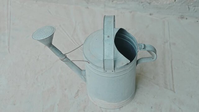 Vintage Metal Watering Can on Light Background Gardening Concept