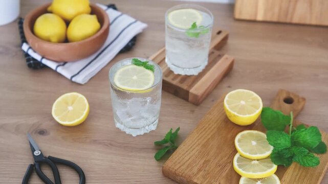 Lemons and ice drinks on a wooden background