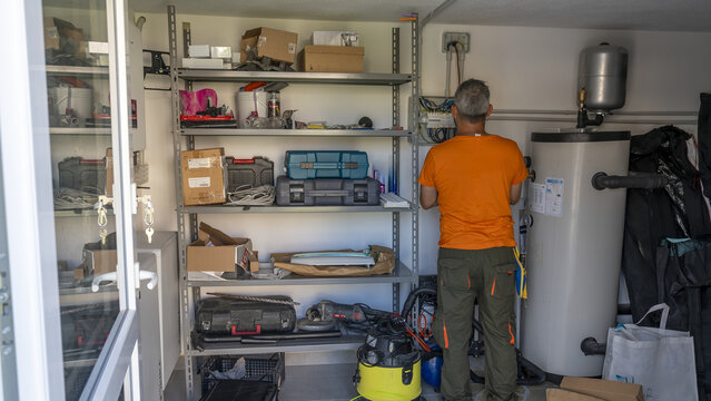 Electrician installing electrical wiring system during house construction or renovation