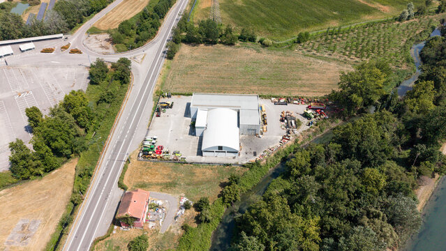 Industrial Estate Aerial View: An expansive aerial perspective showcases an industrial complex situated amidst a rural landscape, Tavazzano con Villavesco, Lodi, Italy