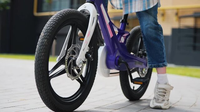 Close Up Of Bicycle Pedals And Wheels With Girl