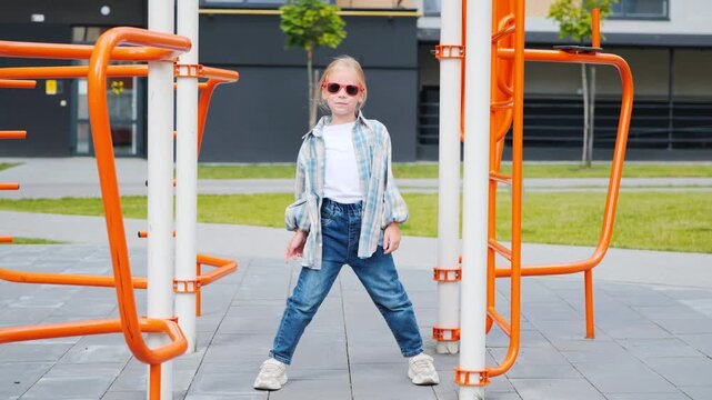 Confident Girl Playing On Monkey Bars In Urban Courtyard