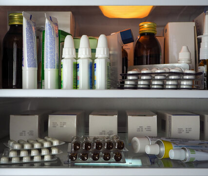 Storage of medical products in a refrigerator. Refrigerator shelves filled with various medicines in boxes, blister packs, and tubes. Background for pharmacies, the industry, business, and clinics.