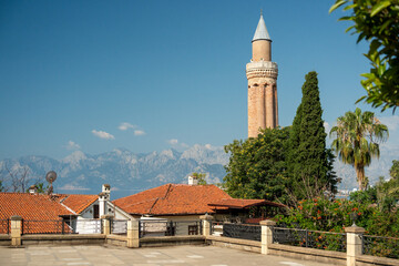 Fototapeta premium Historic Yivli Minaret Mosque and Taurus mountains in Antalya Turkey