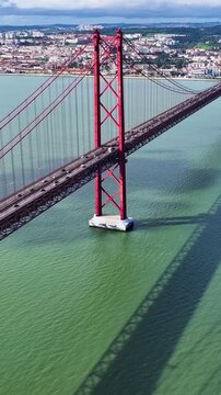 25 Of April Bridge At Lisbon In Lisbon District Portugal. Downtown City Skyline. Transportation Scenery. 25 Of April Bridge At Lisbon In Lisbon District Portugal. Famous Cable Stayed Bridge.