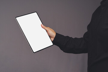 Person holding tablet with blank white screen mockup © meeboonstudio