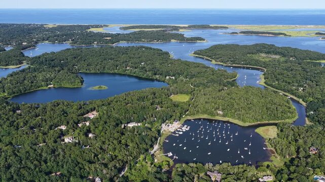Healthy forest and marsh surrounds freshwater lakes and the scenic Arey's Pond in Orleans, Cape Cod, MA. This area of New England is a perfect area for sailboats during the warm summer months.
