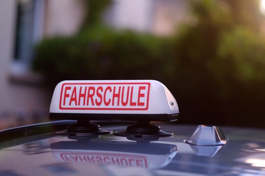 German driving school car roof sign. Horizontal image with selective focus. 