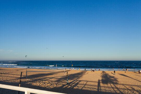 beach volleyball net with distant people on the seashore