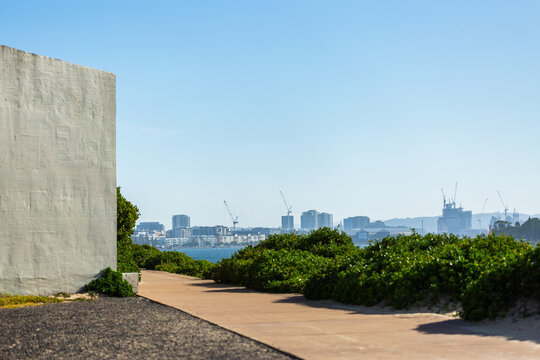 Walkway along Newcastle breakwater on sunlit day in Australia