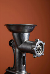 Fototapeta premium Vintage metal meat grinder isolated on warm background