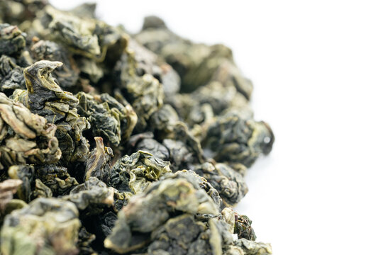 Green oolong tea closeup with white backdrop