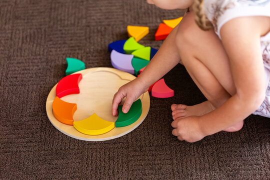 child doing colourful puzzle motor skills developmental toy