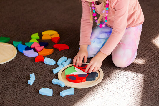 kid playing with wooden ladybird puzzle motor skills development toy